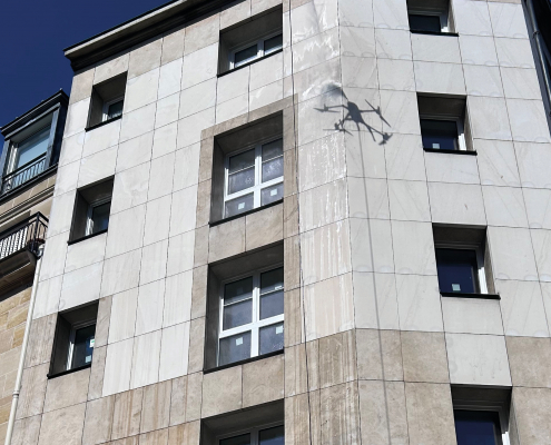 Démoussage par drone de façade sur un immeuble en pierre